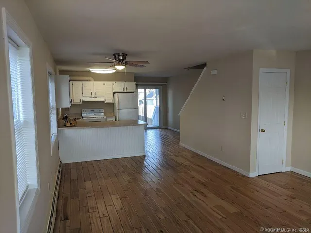 a view of a kitchen with a sink and wooden floor