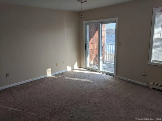 an empty room with windows and closet