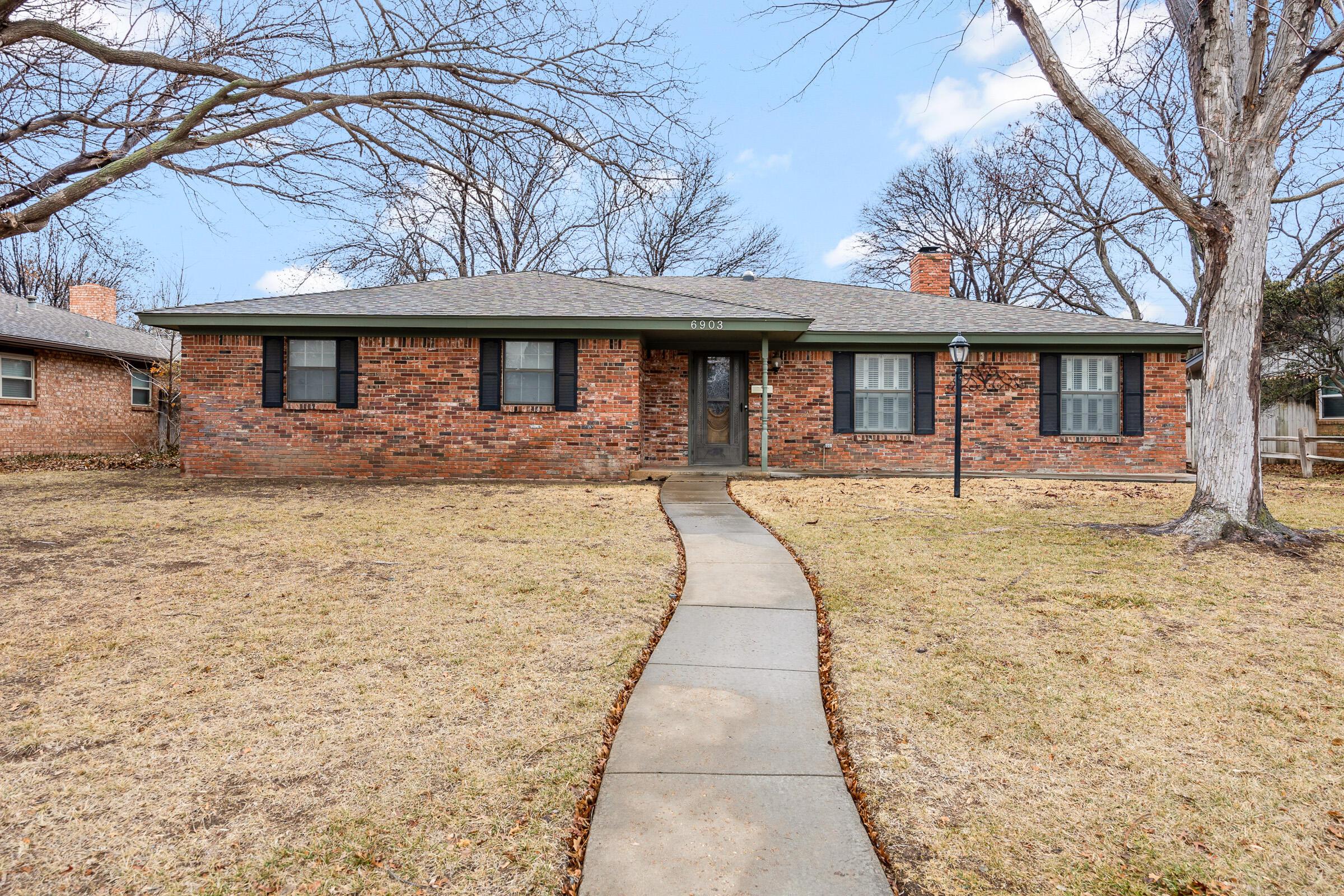 6903 Dreyfuss Road Amarillo, TX 79106 - Photo 1 of 27 a front view of a house with a yard