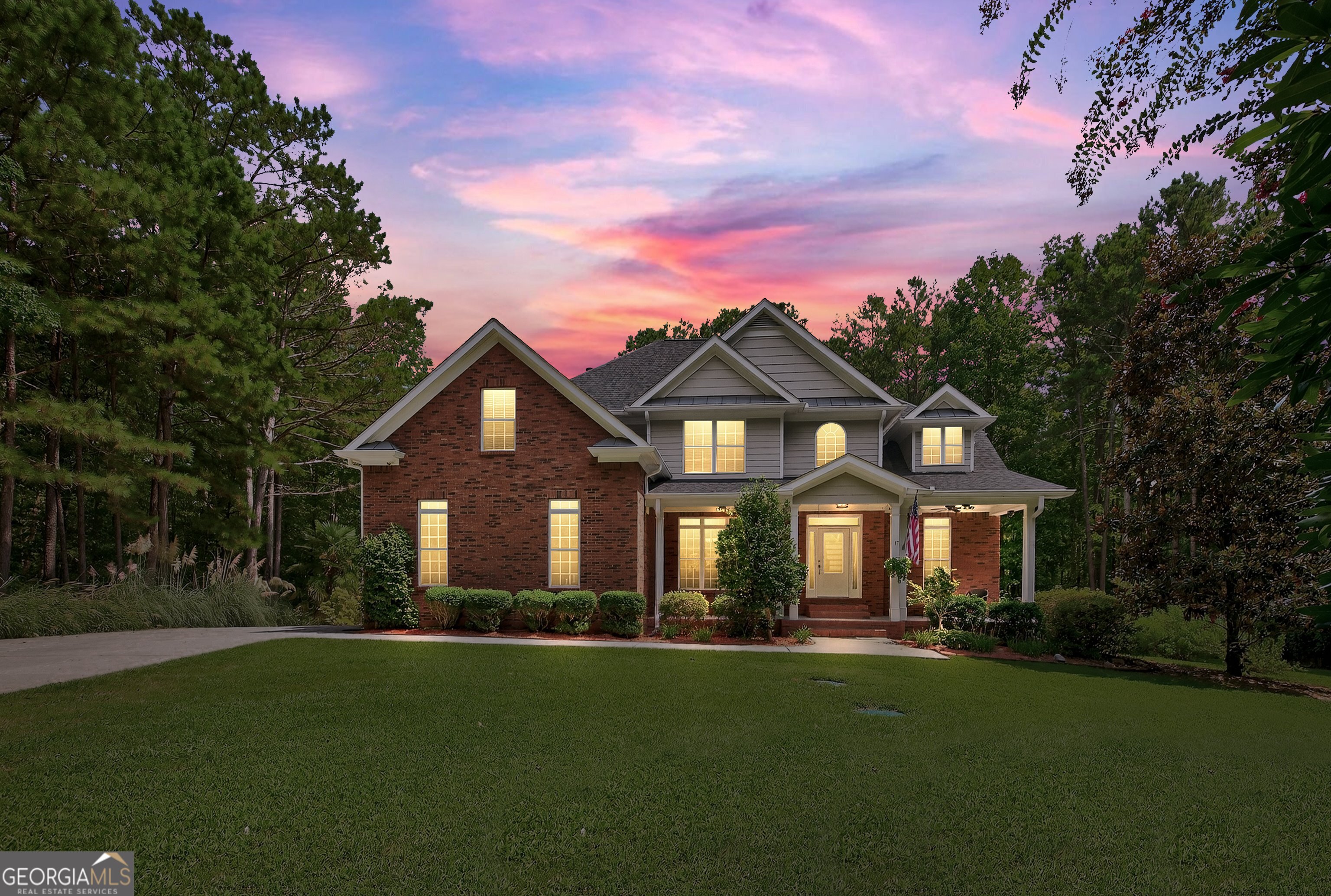 a front view of a house with a garden