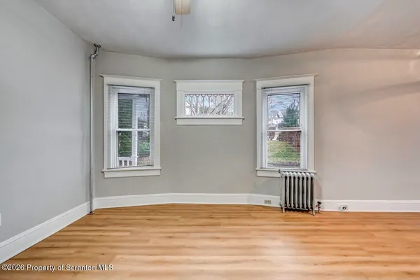 a kitchen with granite countertop cabinets stainless steel appliances and wooden floor