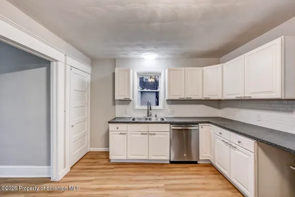 a bathroom with a toilet sink and shower