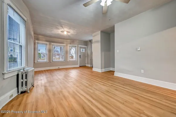wooden floor in an empty room with a window