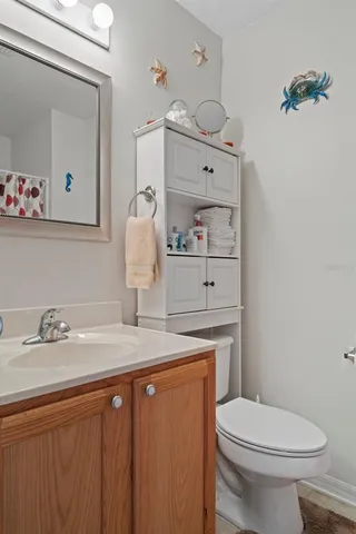 a bathroom with a sink a toilet and vanity