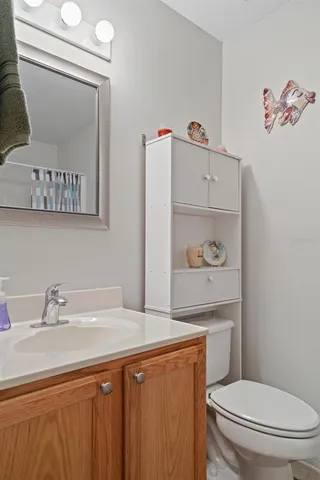 a bathroom with a sink a toilet and a mirror