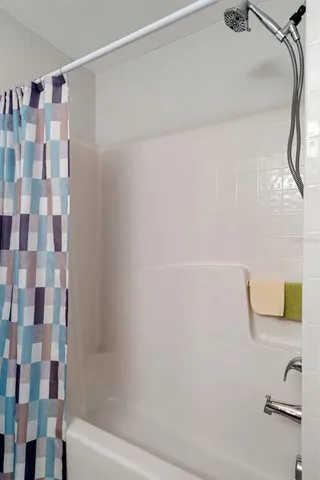 a bathroom with a shower and a sink