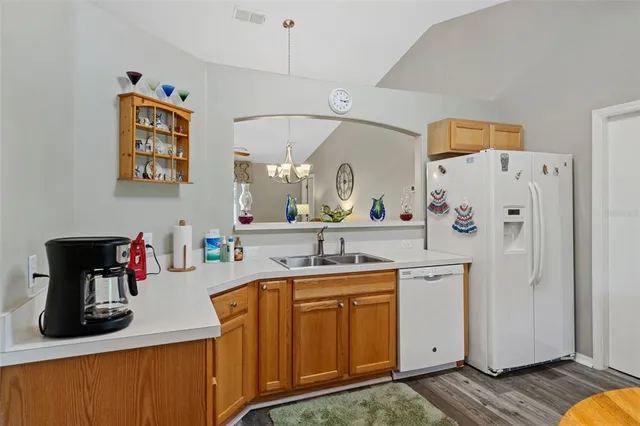 a kitchen with stainless steel appliances a sink and refrigerator