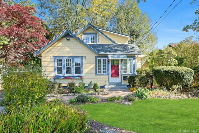 a front view of a house with a yard table and chairs
