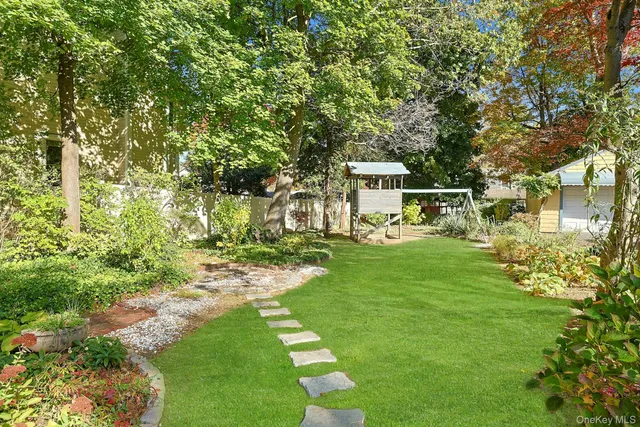 a view of a chair and table on the garden
