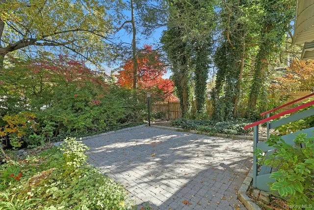 a view of a house with backyard and a tree