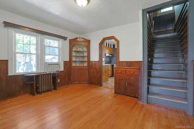 a view of empty room with cabinet and windows