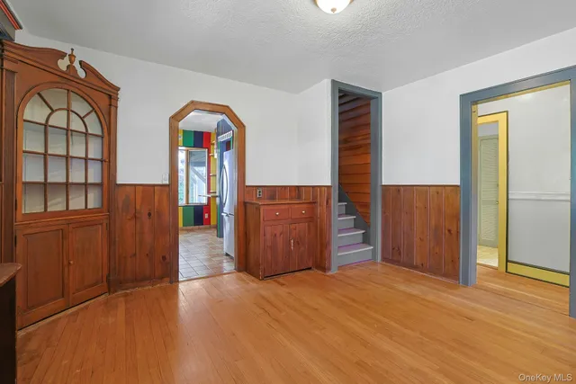 a view of front door with wooden floor and cabinet