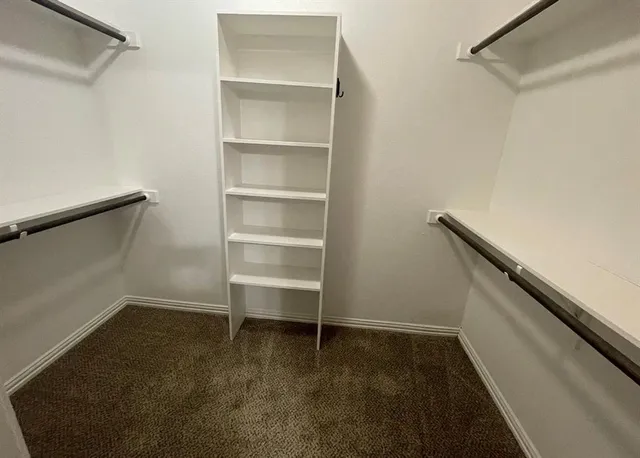 a view of an empty walk in closet