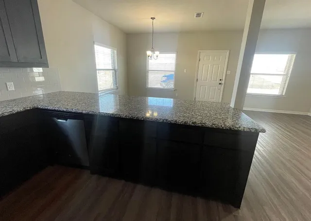 a kitchen with granite countertop counter top space cabinets and a window