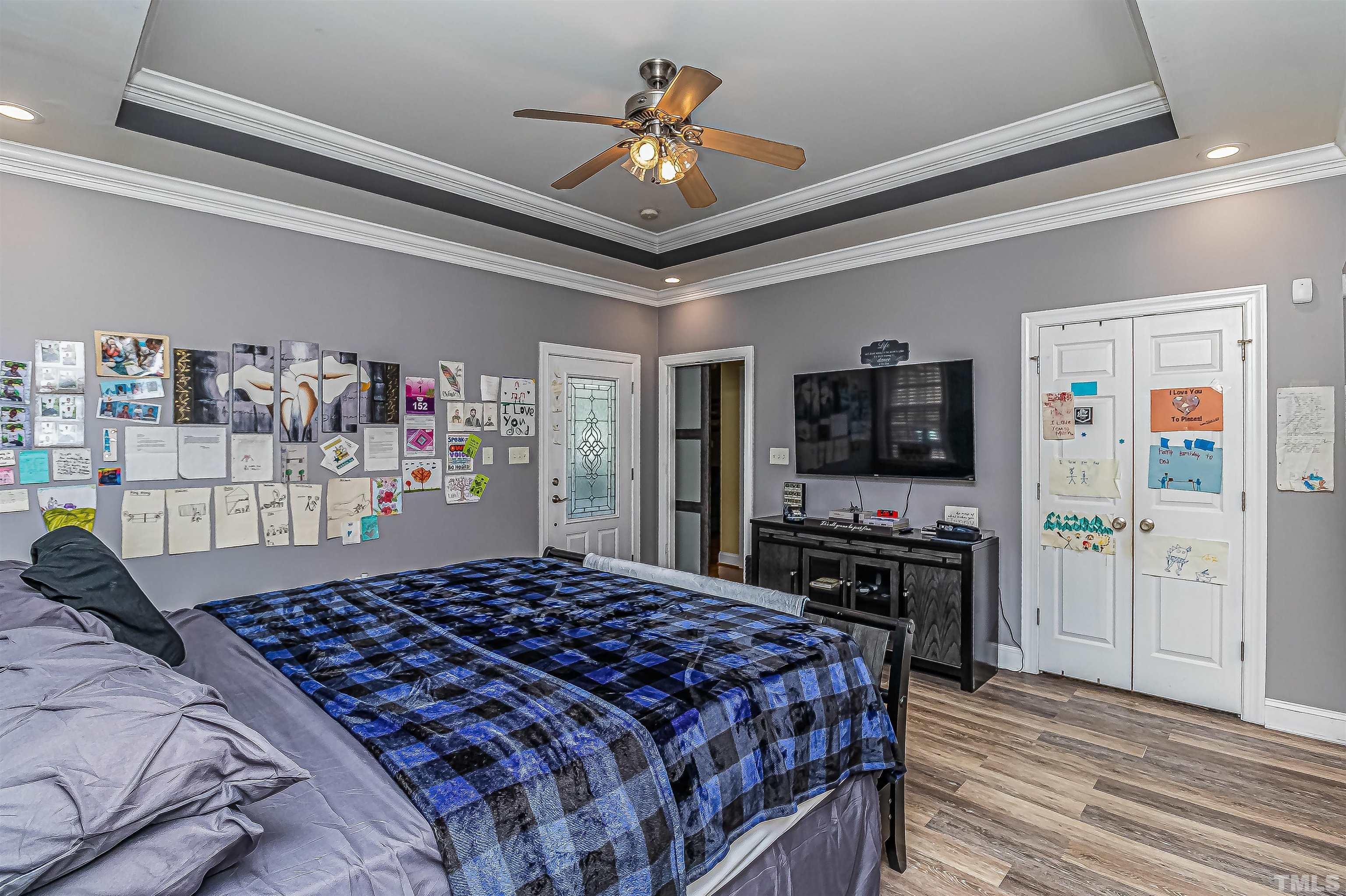 1197 Trotters Ridge Road Stem, NC 27581 - Photo 12 of 79 a bedroom with a bed and a flat tv screen on dresser