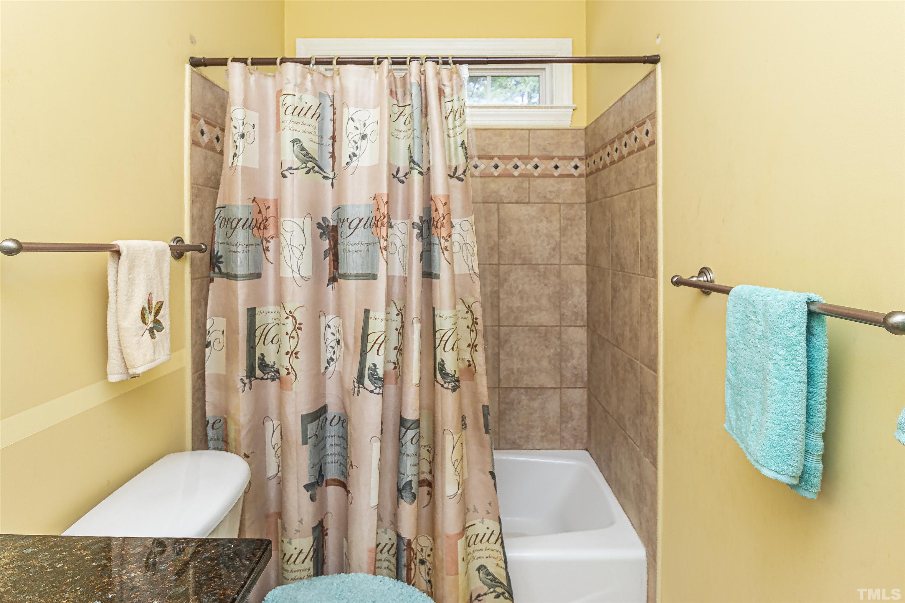 1197 Trotters Ridge Road Stem, NC 27581 - Photo 19 of 79 a bathroom with a shower curtain and a sink