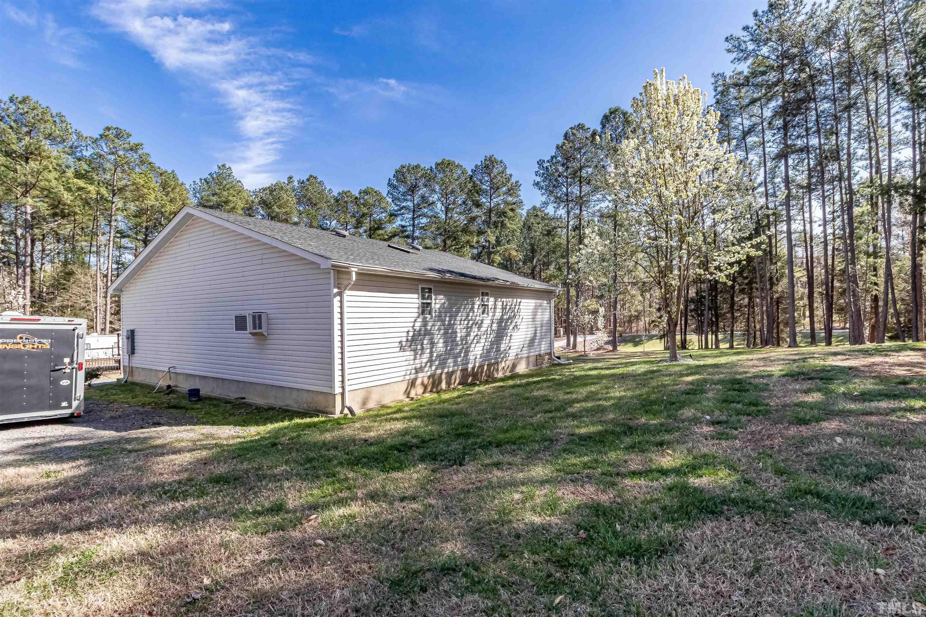 1197 Trotters Ridge Road Stem, NC 27581 - Photo 5 of 79 a backyard of a house with lots of green space