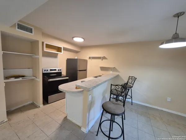 a kitchen with a table and chairs