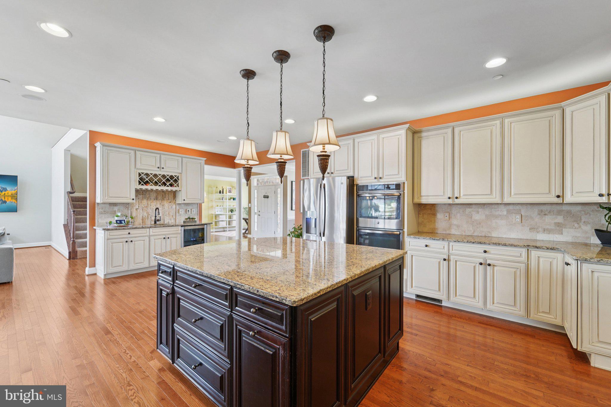 420 Irish Rebel Road Westminster, MD 21157 - Photo 18 of 71 a kitchen with stainless steel appliances granite countertop a refrigerator a sink and wooden floors