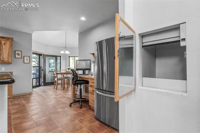 a view of a kitchen with kitchen island dining table and chairs