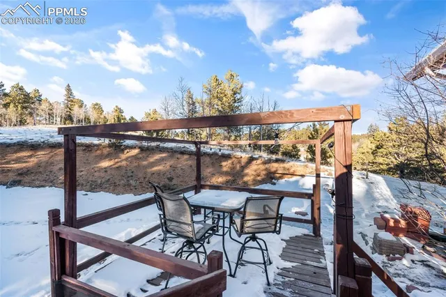 a view of a patio with couches table and chairs and wooden floor