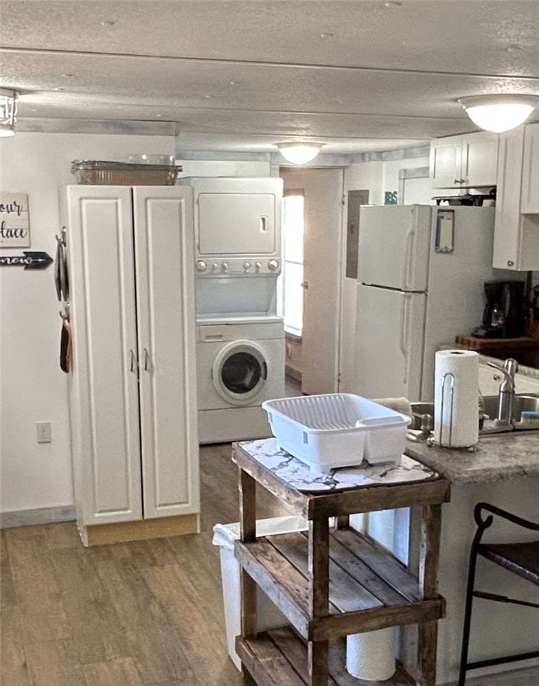 43 Sunset Cove Road Abbeville, SC 29620 - Photo 8 of 41 This kitchen and laundry area offers practical living solutions with durable flooring and functional appliances.
