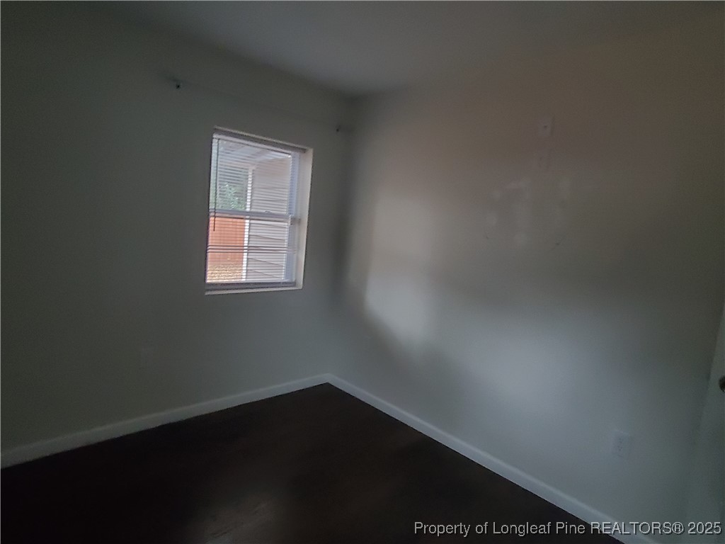 Undisclosed Address Fayetteville, NC 28305 - Photo 11 of 15 an empty room with wooden floor and windows