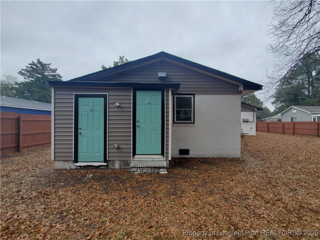 Undisclosed Address Fayetteville, NC 28305 - Photo 14 of 15 a front view of house with yard and trees in the background