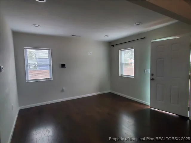 a kitchen with a sink a refrigerator and wooden cabinets