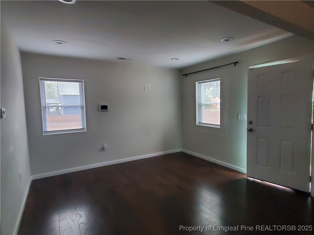 Undisclosed Address Fayetteville, NC 28305 - Photo 5 of 15 a view of an empty room with wooden floor and a window