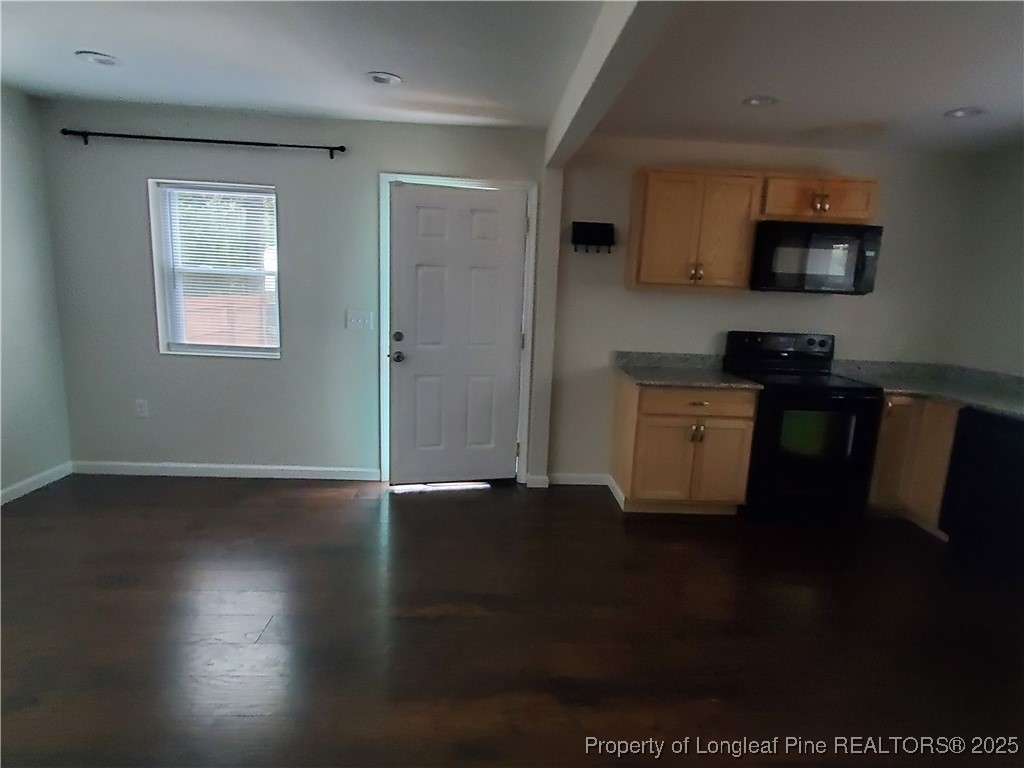 Undisclosed Address Fayetteville, NC 28305 - Photo 7 of 15 a kitchen with granite countertop a stove a sink and a microwave