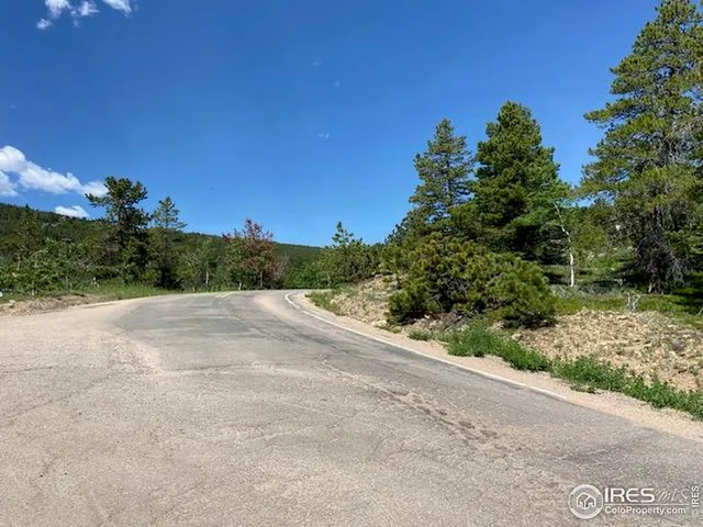 a view of a road with a building in the background