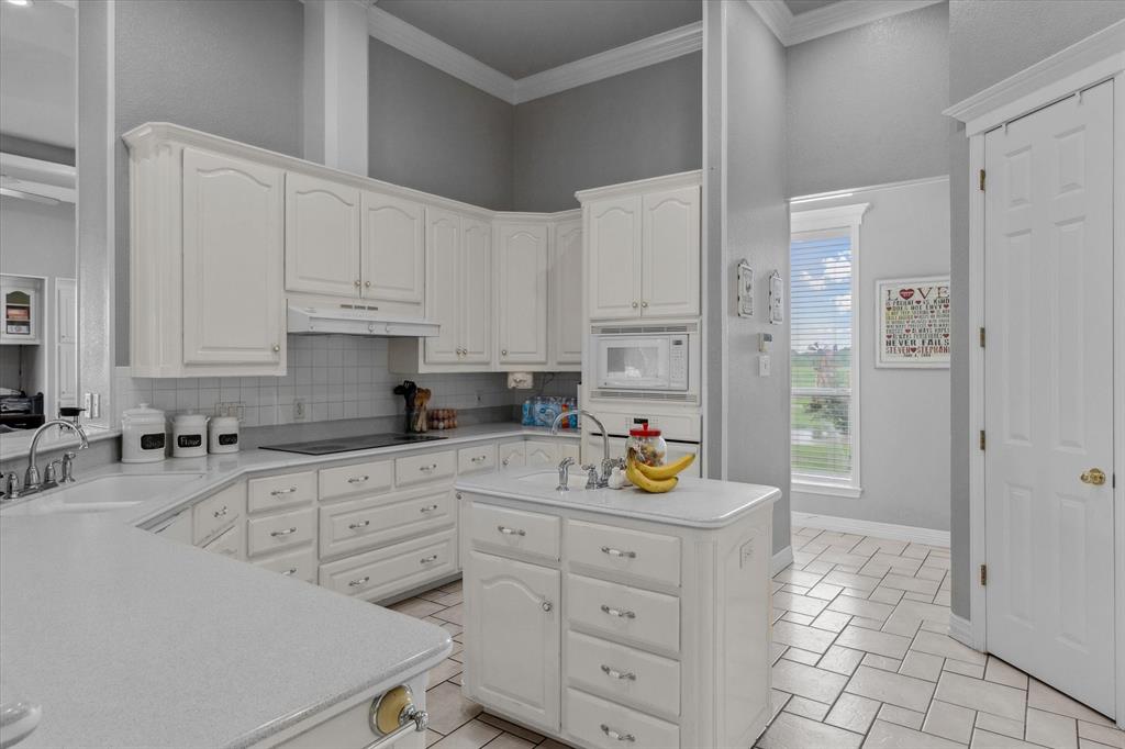 7182 Fm 2451 Road Scurry, TX 75158 - Photo 13 of 37 a kitchen with white cabinets and appliances