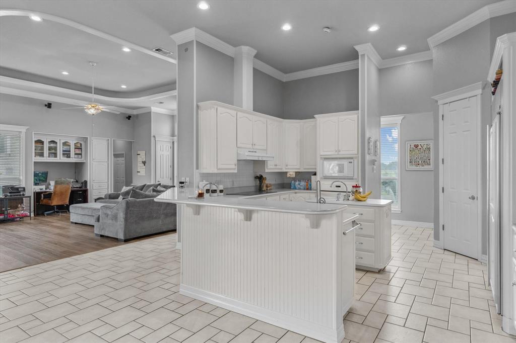 7182 Fm 2451 Road Scurry, TX 75158 - Photo 14 of 37 a kitchen with stainless steel appliances kitchen island granite countertop a refrigerator and a sink