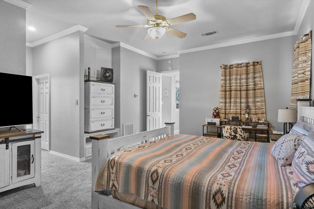 7182 Fm 2451 Road Scurry, TX 75158 - Photo 23 of 37 a bedroom with a bed flat screen tv and a large window