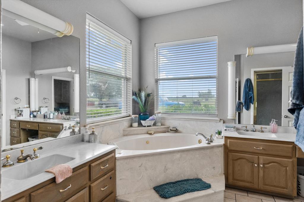 7182 Fm 2451 Road Scurry, TX 75158 - Photo 24 of 37 a bathroom with a sink double vanity and a mirror