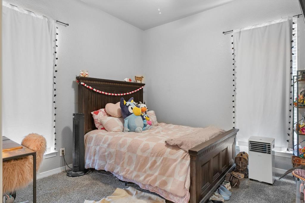 7182 Fm 2451 Road Scurry, TX 75158 - Photo 25 of 37 a bedroom with a bed and furniture