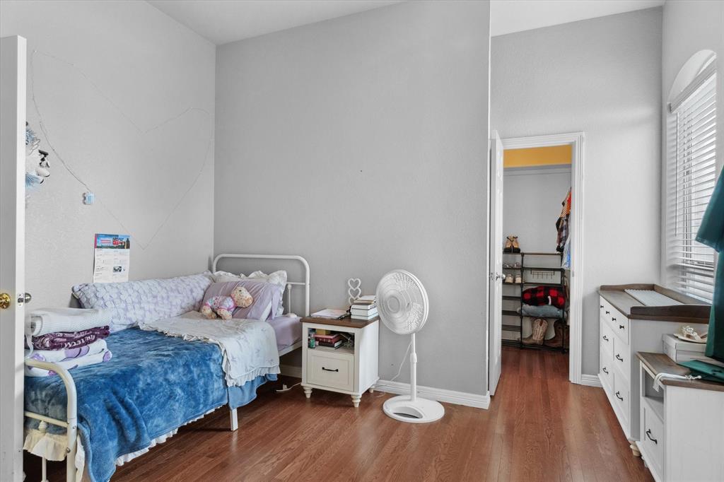 7182 Fm 2451 Road Scurry, TX 75158 - Photo 29 of 37 a bedroom with a bed and wooden floor