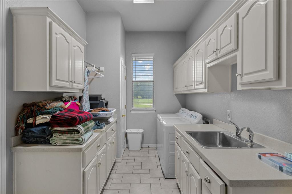 7182 Fm 2451 Road Scurry, TX 75158 - Photo 30 of 37 a kitchen with a sink cabinets and utility