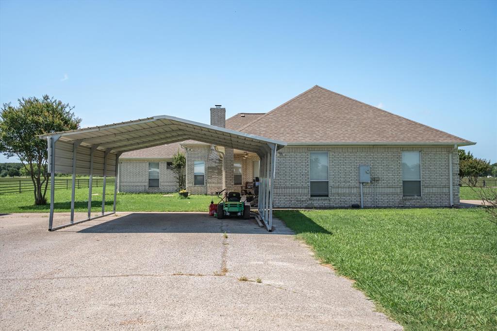 7182 Fm 2451 Road Scurry, TX 75158 - Photo 34 of 37 a front view of house with yard and green space