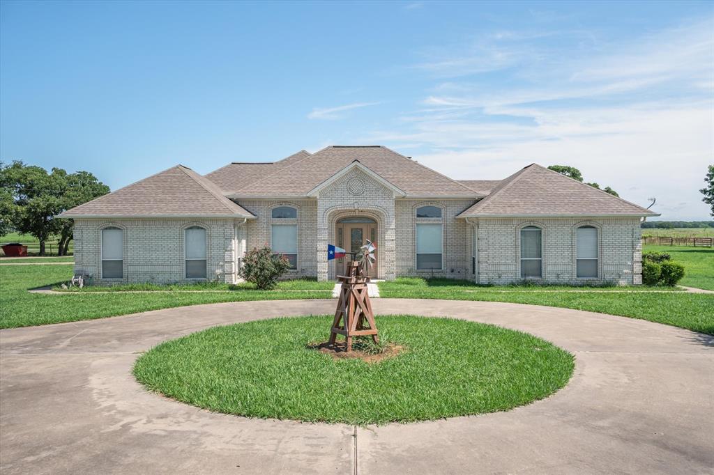 7182 Fm 2451 Road Scurry, TX 75158 - Photo 5 of 37 a front view of a house with a yard and garage