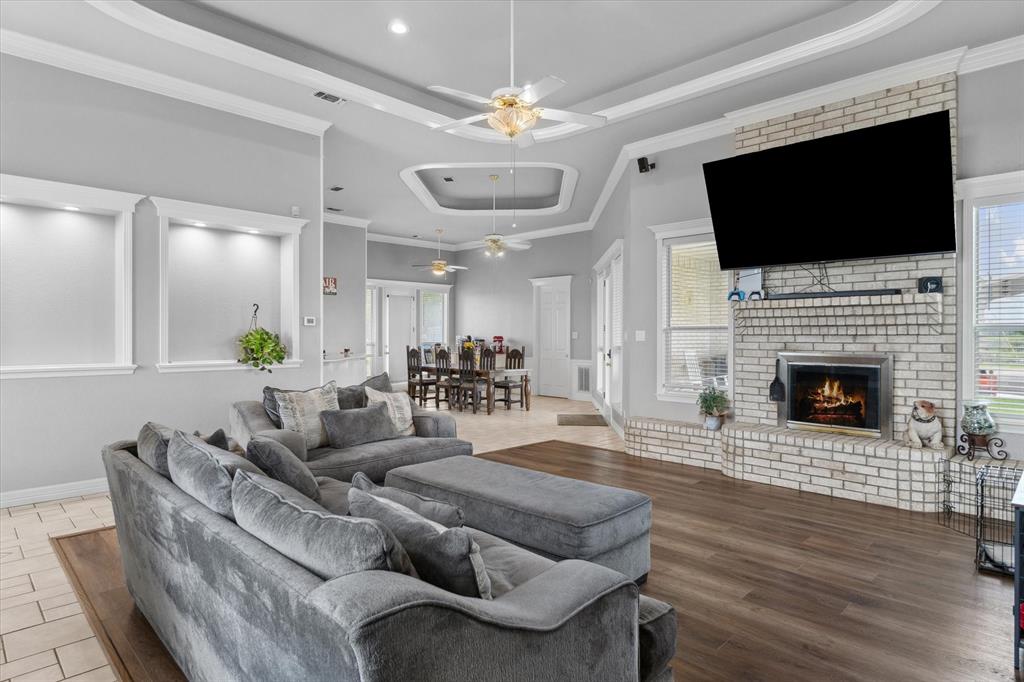 7182 Fm 2451 Road Scurry, TX 75158 - Photo 8 of 37 a living room with furniture a flat screen tv and a fireplace