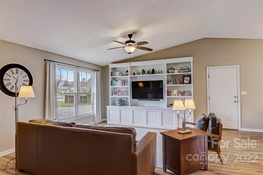 497 Fanning Bridge Road Fletcher, NC 28732 - Photo 11 of 41 a living room with furniture a flat screen tv and kitchen view