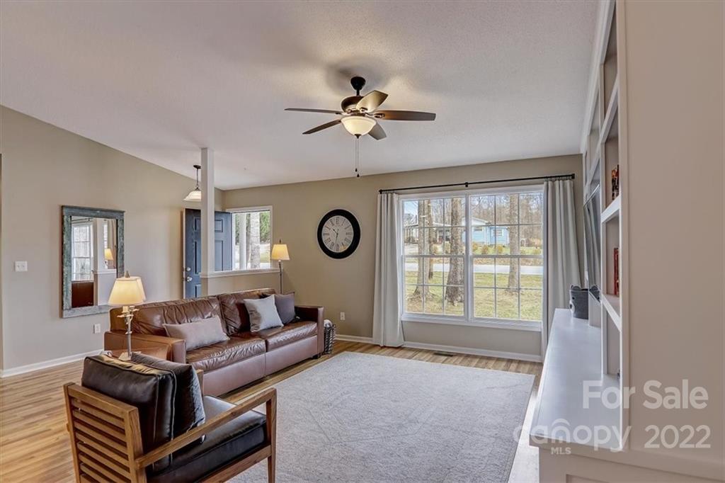 497 Fanning Bridge Road Fletcher, NC 28732 - Photo 12 of 41 a living room with furniture a window and a ceiling fan