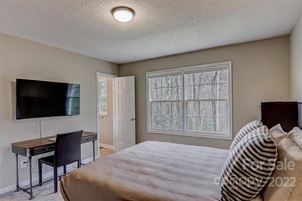 497 Fanning Bridge Road Fletcher, NC 28732 - Photo 34 of 41 a bedroom with a bed and a flat screen tv