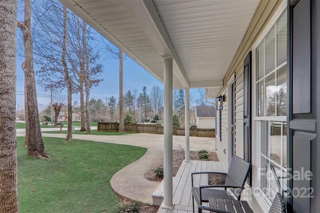 497 Fanning Bridge Road Fletcher, NC 28732 - Photo 4 of 41 a view of a patio with a table chairs and a backyard