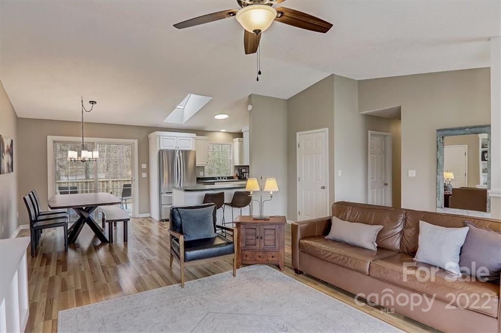 497 Fanning Bridge Road Fletcher, NC 28732 - Photo 6 of 41 a living room with furniture kitchen view and a chandelier