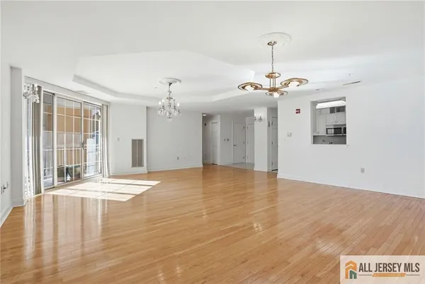 a view of a livingroom with wooden floor and a ceiling fan