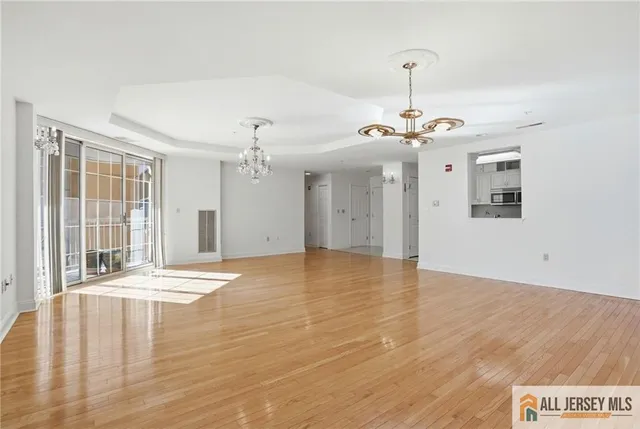 a view of a livingroom with wooden floor and a ceiling fan