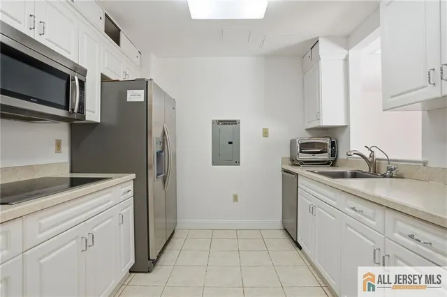 a kitchen with a sink and steel appliances